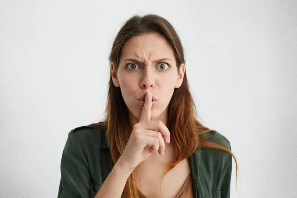 Mujer molesta con signo silencio